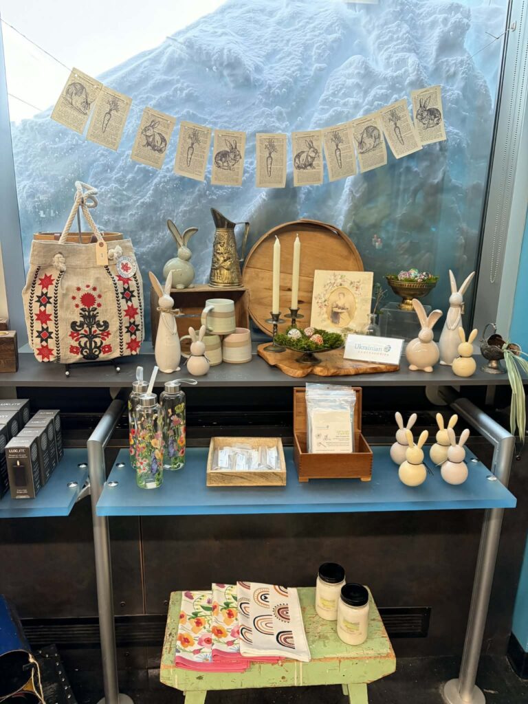 Assorted candles and figurines sit on table in gift shop